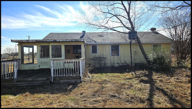 rear view of property featuring a wooden deck