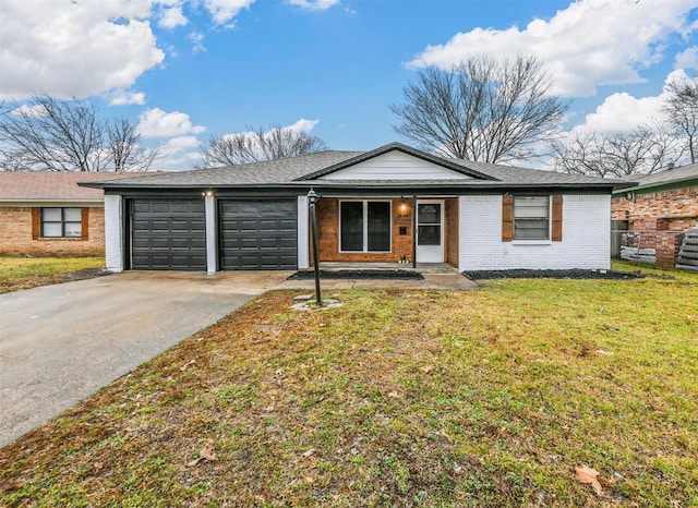 ranch-style home featuring a garage and a front lawn