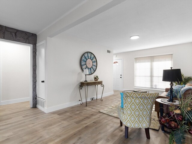 dining room featuring light hardwood / wood-style flooring and ornamental molding