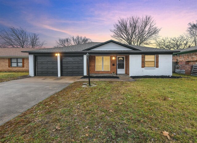 single story home with a front yard and a garage