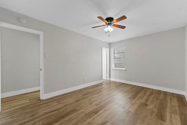 unfurnished room featuring ceiling fan and light wood-type flooring