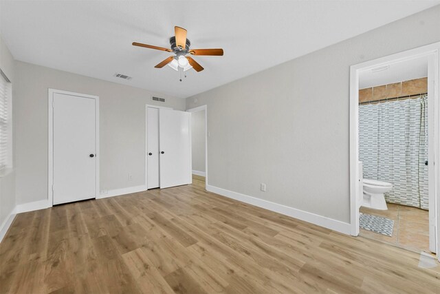 unfurnished bedroom featuring ceiling fan, a closet, and light hardwood / wood-style flooring