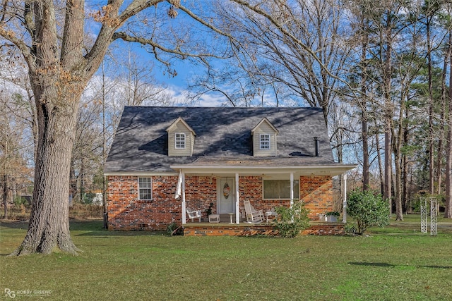 cape cod-style house featuring a front yard and a porch