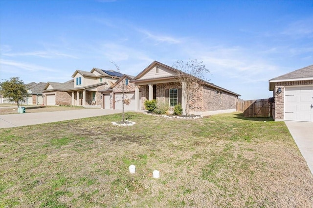 view of front of home with a garage, a front yard, and solar panels