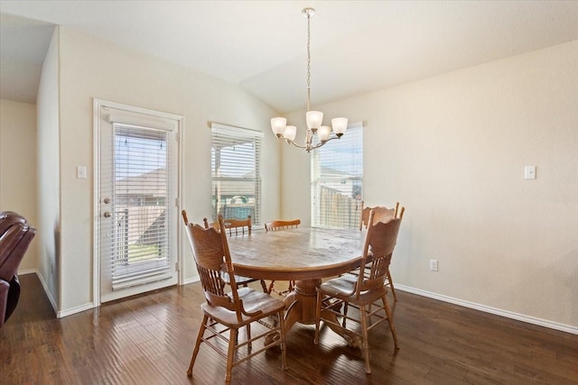 dining space featuring vaulted ceiling, a chandelier, and dark hardwood / wood-style floors