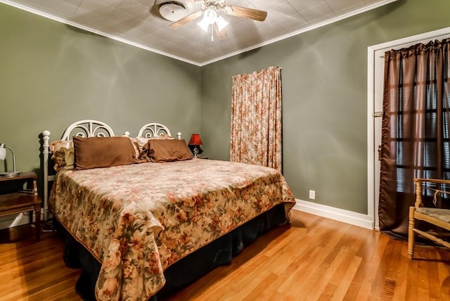 bedroom featuring ceiling fan, hardwood / wood-style flooring, and ornamental molding