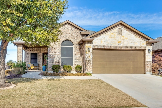 view of front of property with a front lawn and a garage