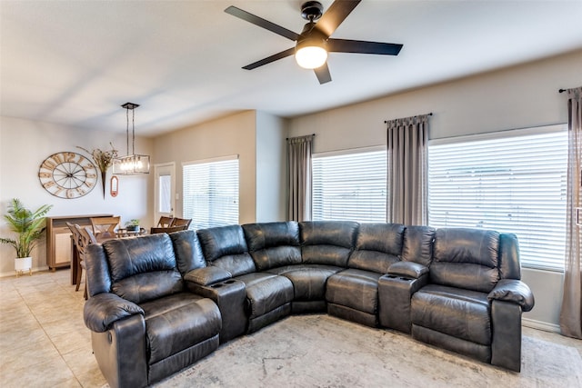 living room with ceiling fan with notable chandelier and light tile patterned flooring