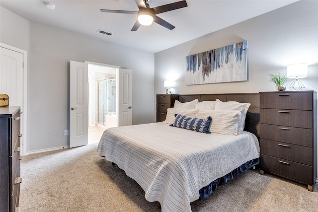 carpeted bedroom with ceiling fan and connected bathroom