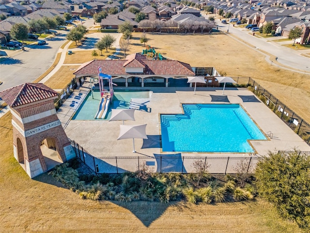 view of pool with a lawn and a patio