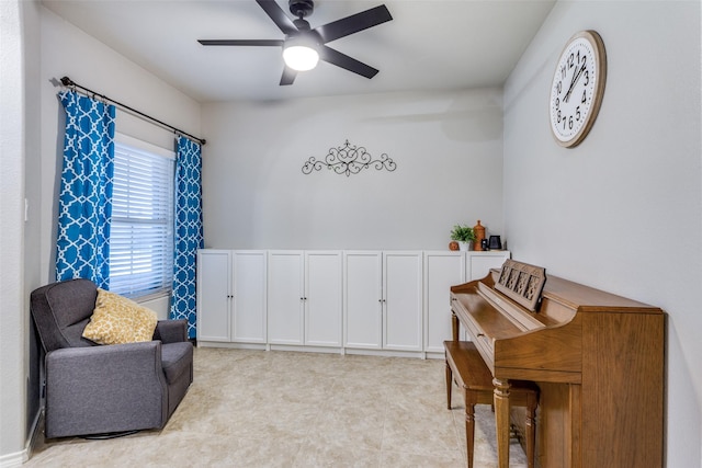 living area with ceiling fan