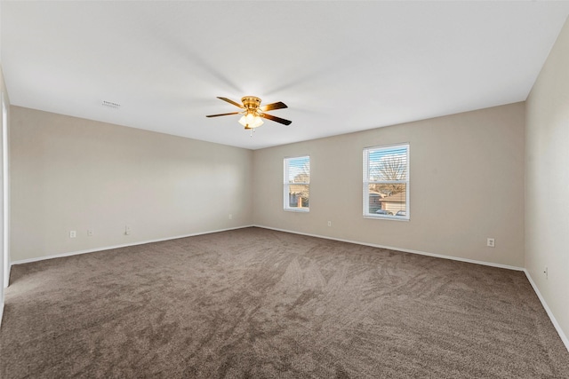 carpeted spare room featuring ceiling fan