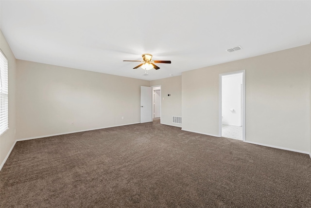 unfurnished room with ceiling fan, dark carpet, and a wealth of natural light