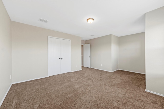 unfurnished bedroom featuring a closet and carpet floors