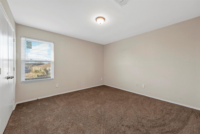 unfurnished bedroom featuring carpet and a closet