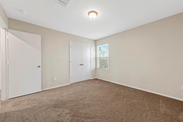 unfurnished bedroom with a closet and carpet flooring