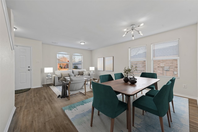 dining space featuring an inviting chandelier and hardwood / wood-style flooring