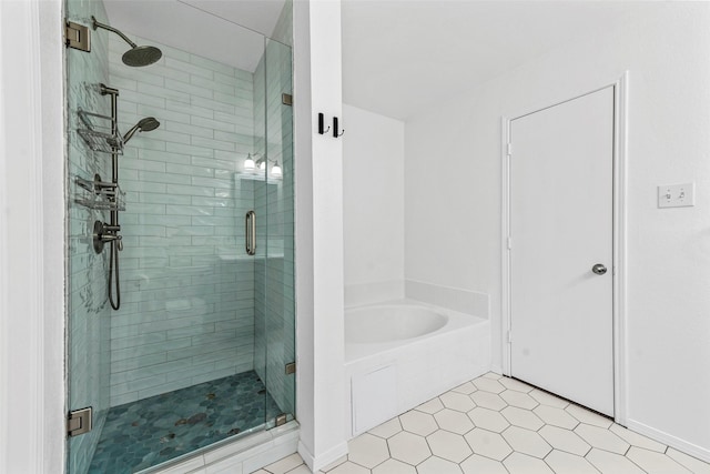 bathroom featuring tile patterned flooring and independent shower and bath