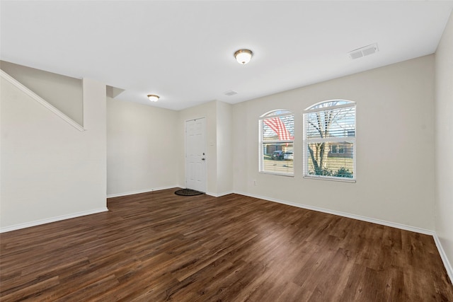 empty room with dark hardwood / wood-style flooring