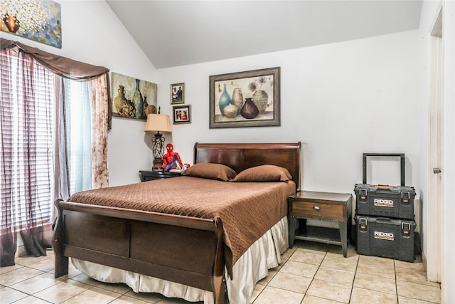 tiled bedroom featuring lofted ceiling