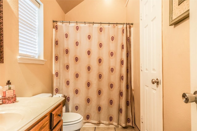 bathroom with toilet, lofted ceiling, vanity, and curtained shower