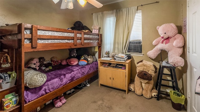 bedroom featuring ceiling fan, cooling unit, and carpet floors