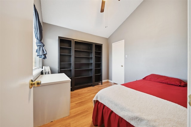 bedroom featuring vaulted ceiling, ceiling fan, a closet, and hardwood / wood-style floors