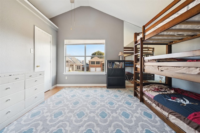 bedroom featuring lofted ceiling and light hardwood / wood-style floors