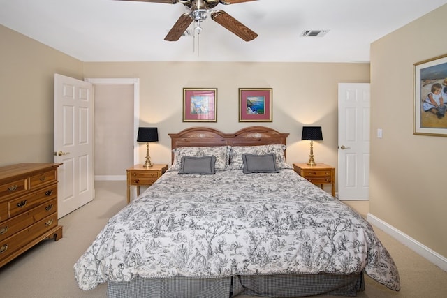 bedroom featuring light colored carpet, baseboards, and a ceiling fan