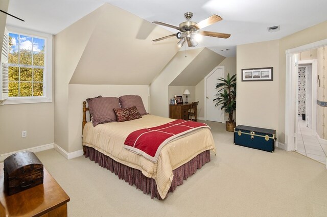 carpeted bedroom featuring baseboards, ceiling fan, and lofted ceiling