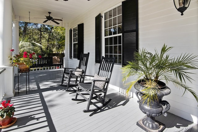 deck featuring covered porch and ceiling fan