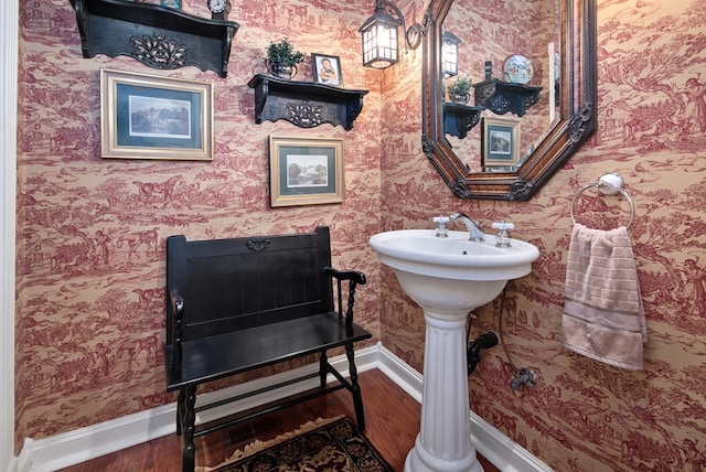 bathroom with wood finished floors and baseboards