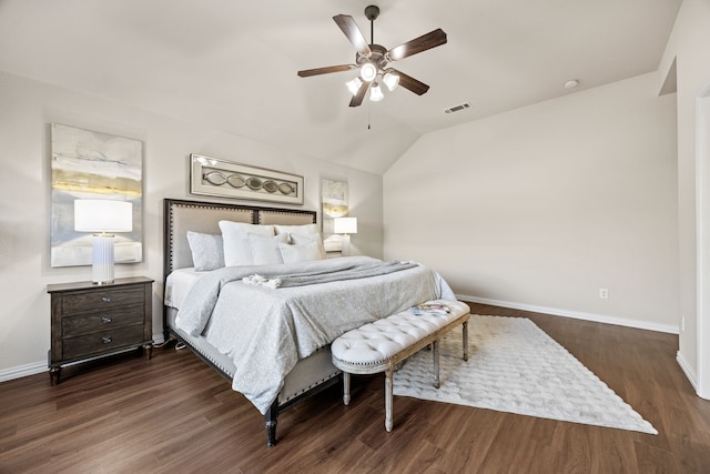 bedroom with dark hardwood / wood-style floors, vaulted ceiling, and ceiling fan