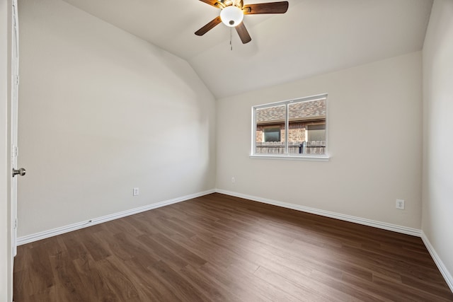 empty room with ceiling fan, dark hardwood / wood-style floors, and vaulted ceiling