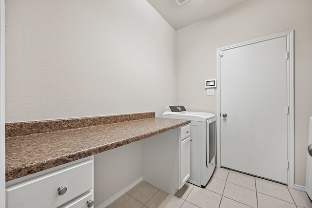 laundry area featuring light tile patterned floors and washer / dryer