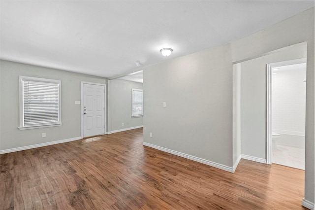 unfurnished room with hardwood / wood-style flooring