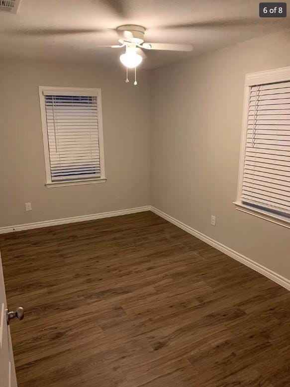 spare room with ceiling fan and dark hardwood / wood-style floors