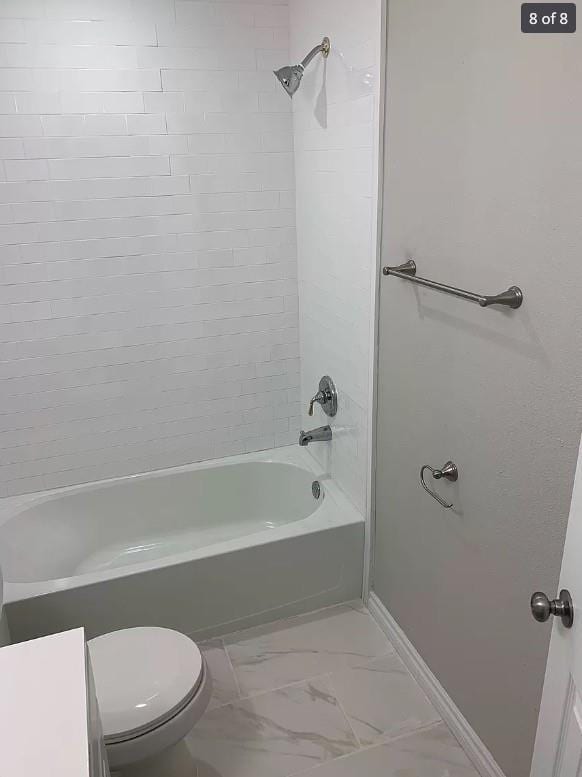 bathroom with toilet and shower / bathtub combination