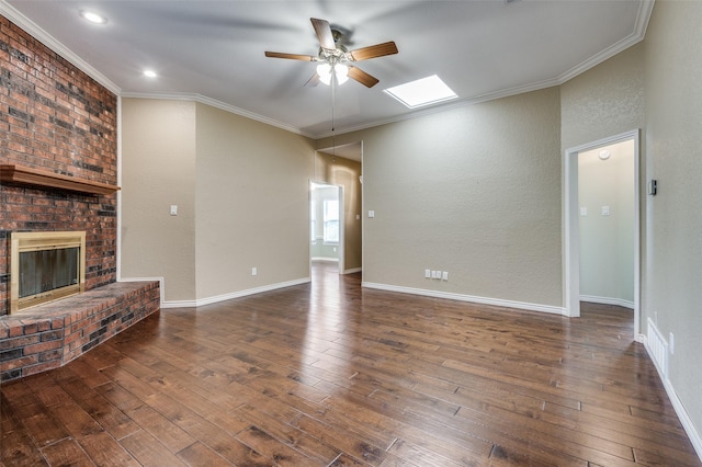 unfurnished living room featuring a brick fireplace, ornamental molding, dark hardwood / wood-style flooring, and ceiling fan