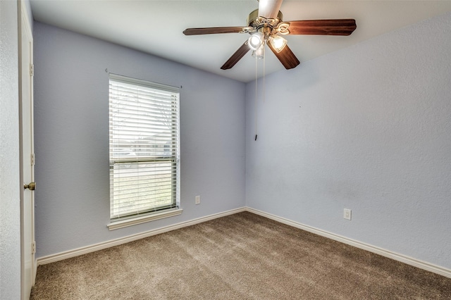 spare room featuring ceiling fan and light colored carpet