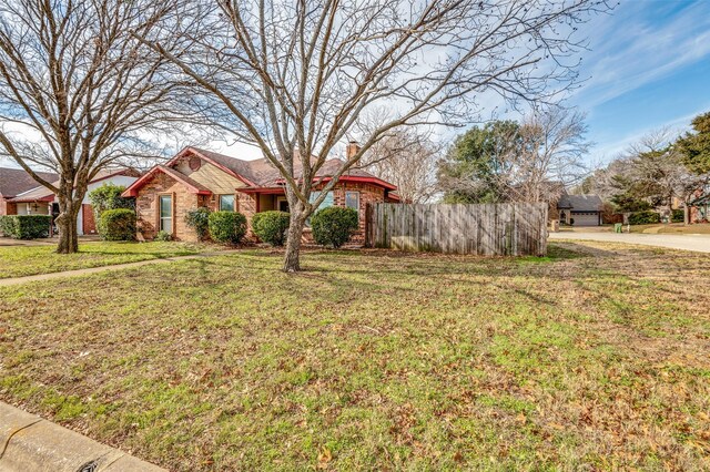 ranch-style home with a front lawn