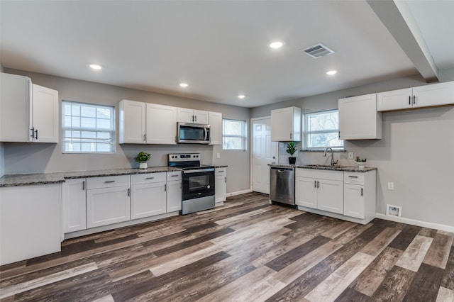 kitchen with white cabinets and appliances with stainless steel finishes