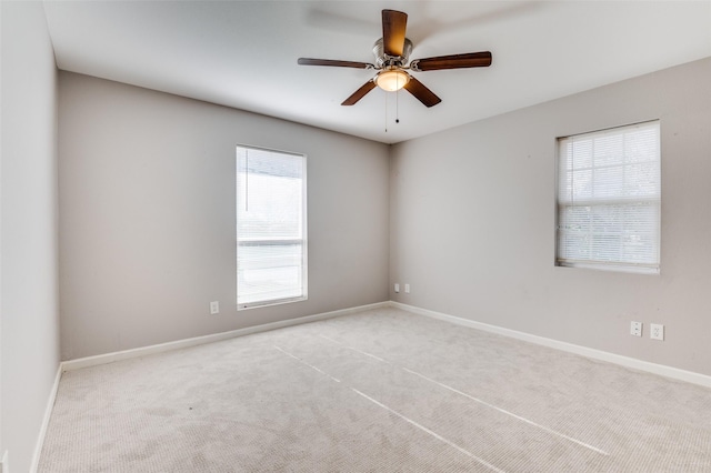 carpeted empty room featuring ceiling fan