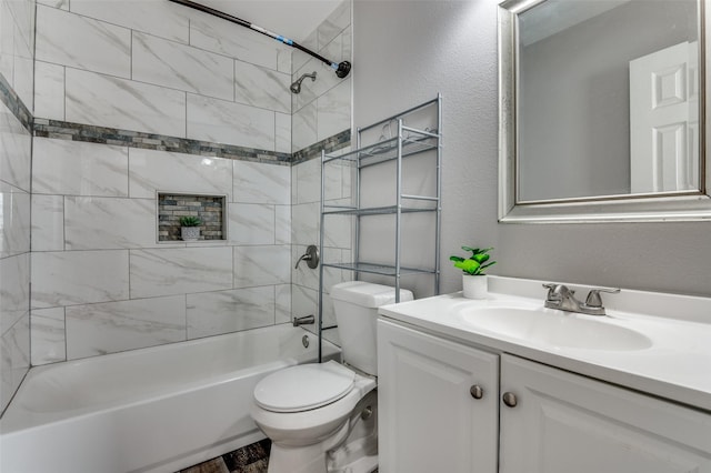 full bathroom featuring toilet, tiled shower / bath, and vanity