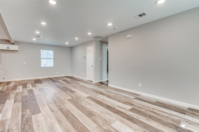 unfurnished room with light wood-type flooring