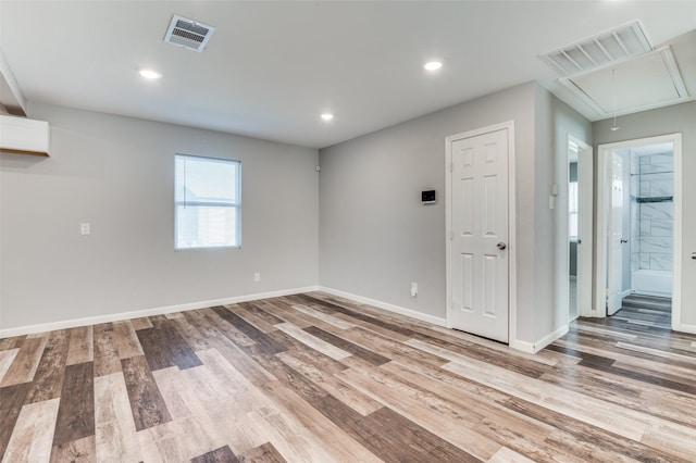 spare room with hardwood / wood-style floors