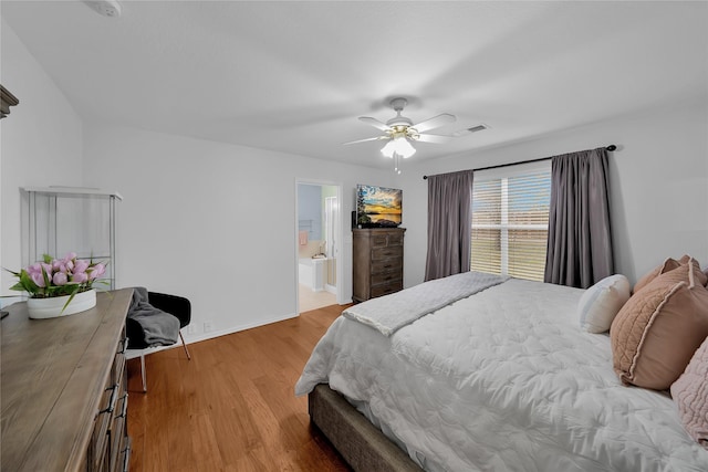 bedroom with connected bathroom, light hardwood / wood-style floors, and ceiling fan