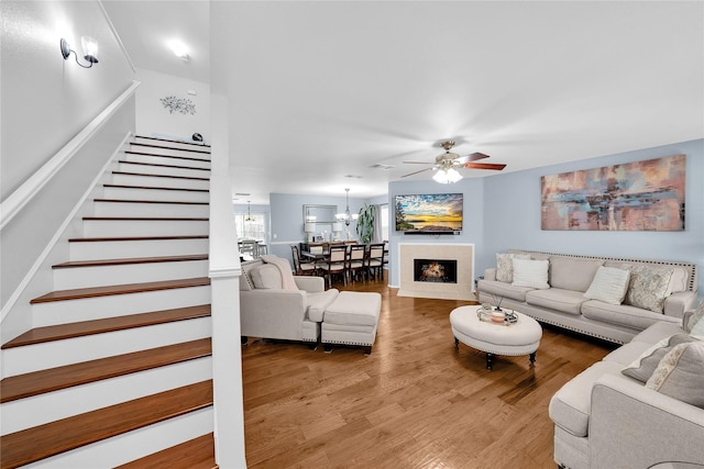 living room with ceiling fan and wood-type flooring