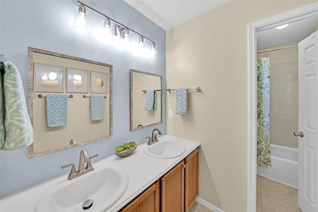 bathroom featuring tile patterned flooring, vanity, and shower / tub combo