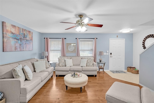 living room with wood-type flooring and ceiling fan